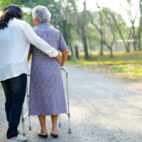 help-care-asian-senior-woman-use-walker-while-walking-park.jpg